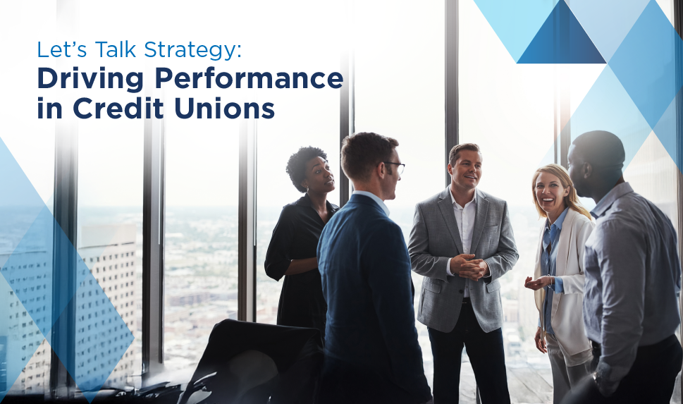 A group of people stand in a conference room. The caption reads: "Let's Talk Strategy: Driving Performance in Credit Unions"
